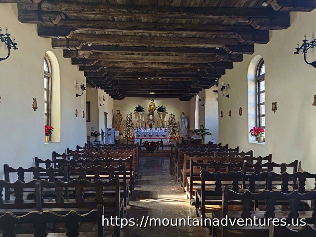 View from the Back of a 1700s Spanish Mission Church. Rows of benches in front of the altar