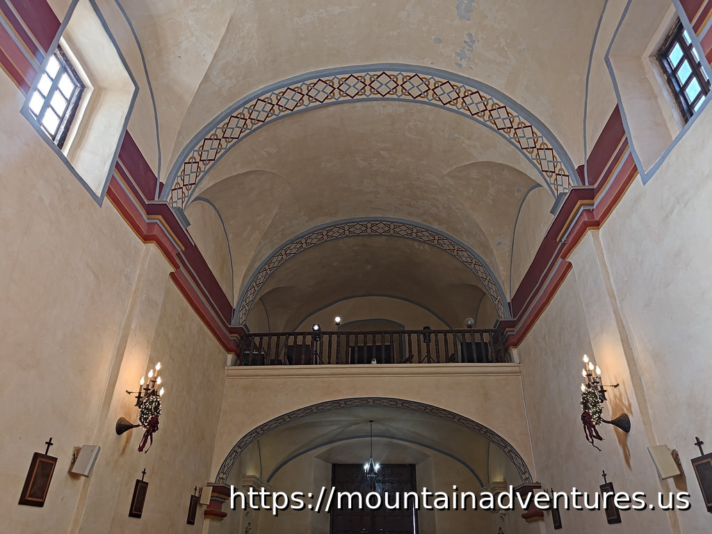 Choir loft and ceiling with decorative art on the walls and ceiling