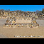 Entrance Sign in Front of a Mission Wall
